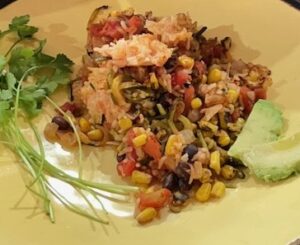 corn salad with avocado slices and cilantro on the side