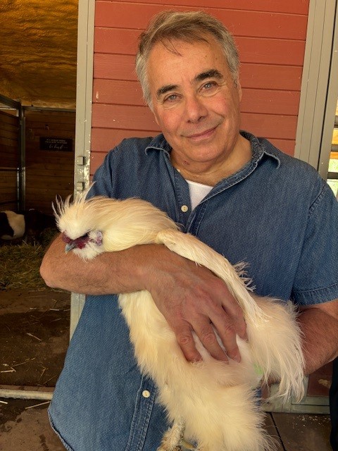 man holding a white chicken